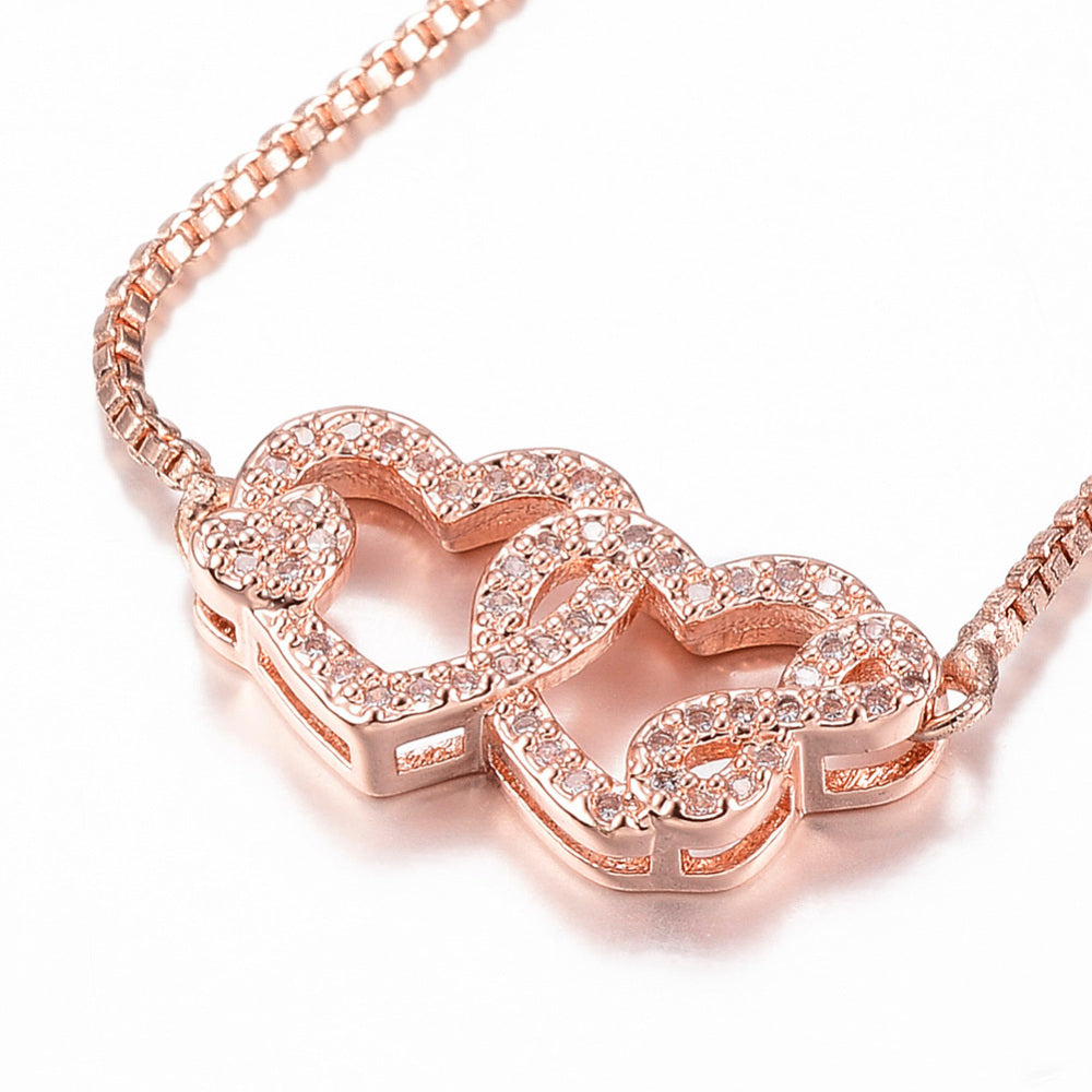 Bracelet double cœur entrelacé – plaqué or rose & zircons